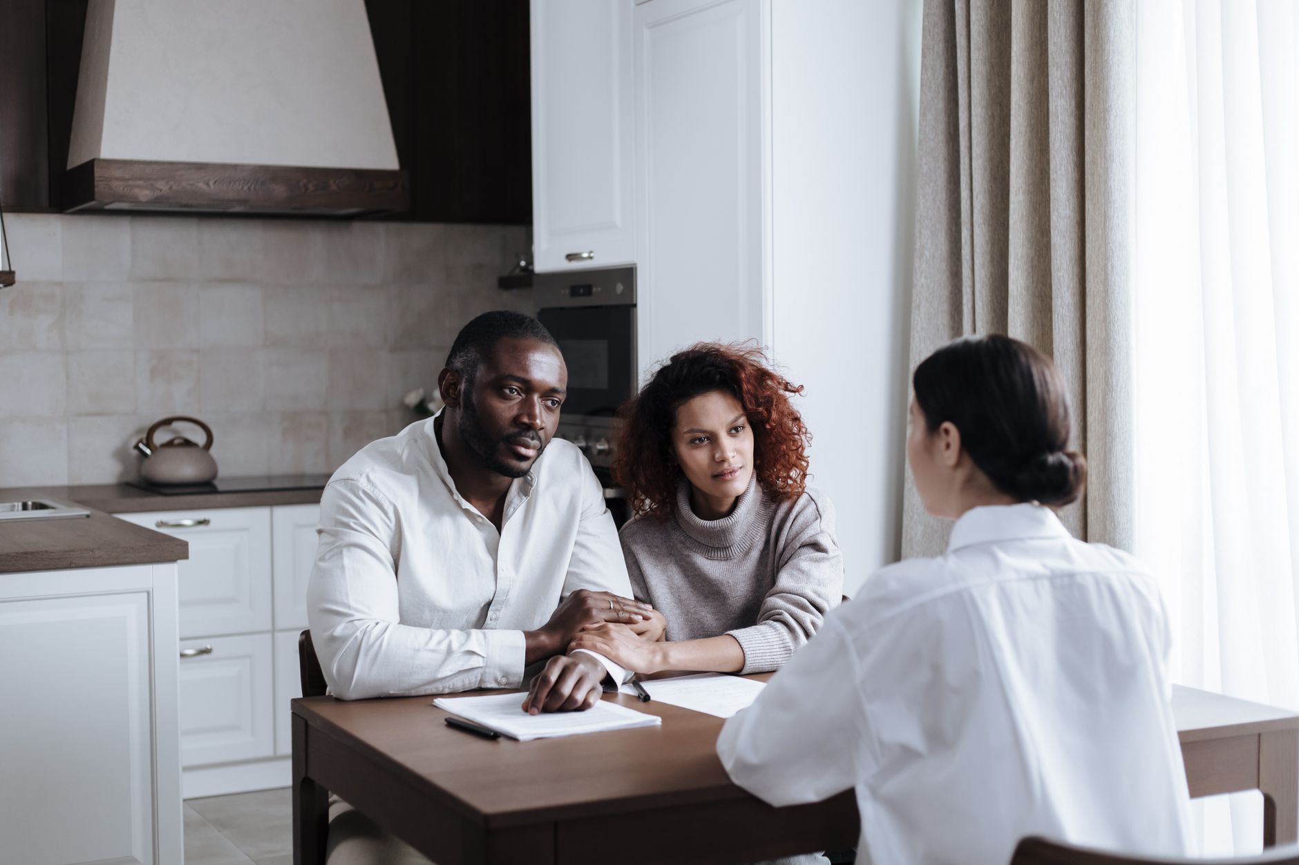 A couple meeting with an advisor at home
