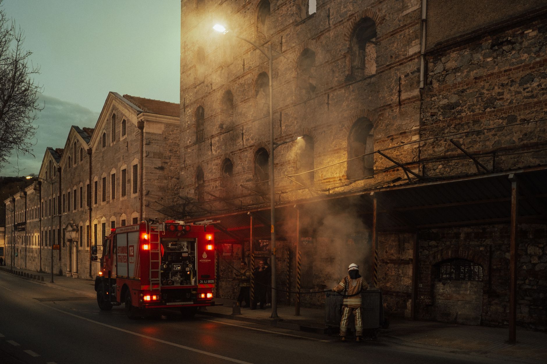 A fire truck on a street at dusk