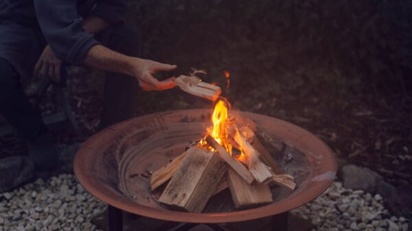 Best fire pit cover: a round fire pit in a backyard at dusk
