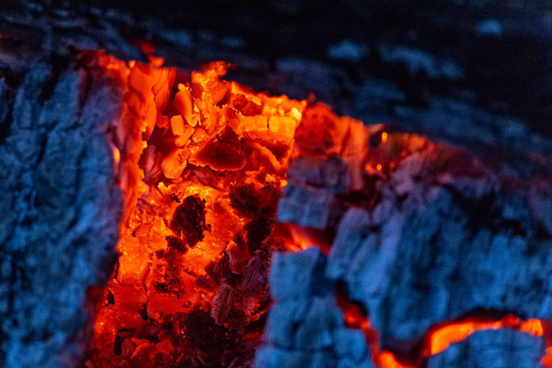 Glowing embers at the bottom of a fire