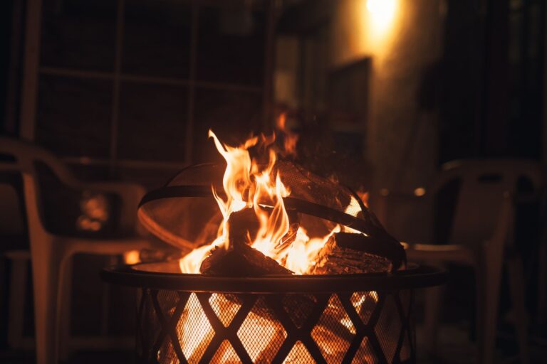 Best fire pit grill: a wood fire burning in a backyard fire pit