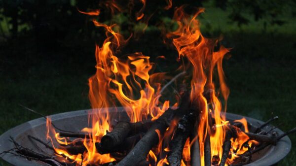 Best fire pit: a wood fire burning in a backyard fire pit at dusk
