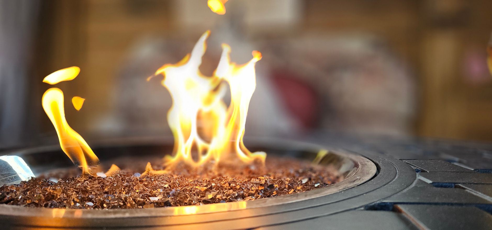 Flames rising from logs in an outdoor fire pit