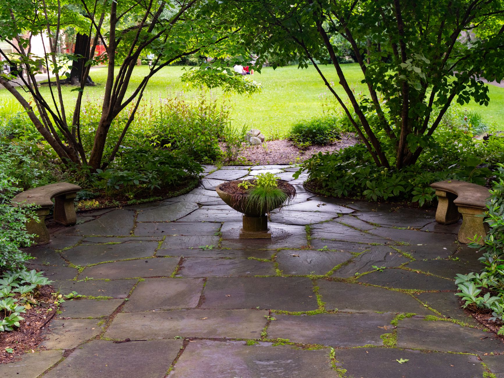 A stone patio in a backyard