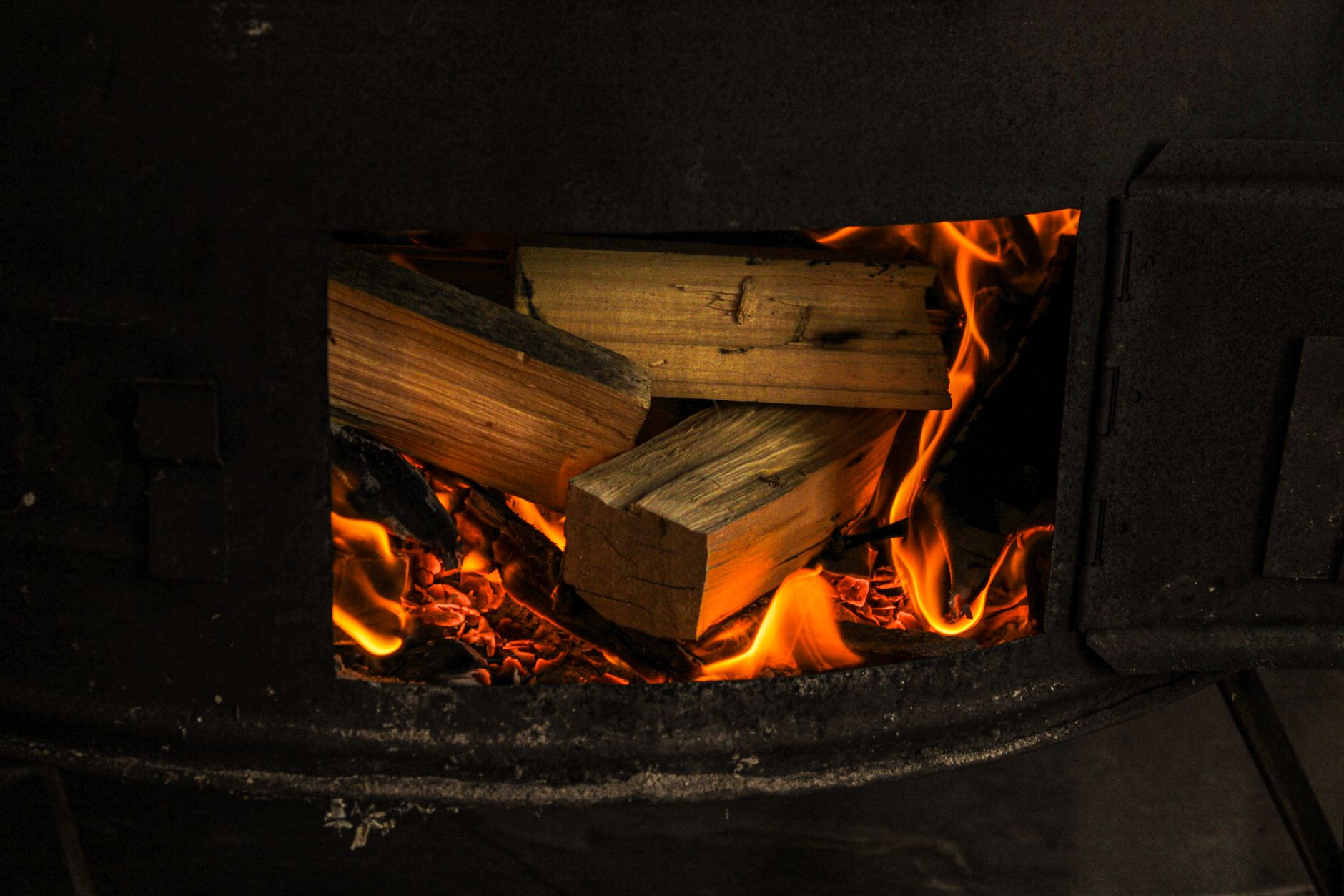 A fire burning inside a wood stove