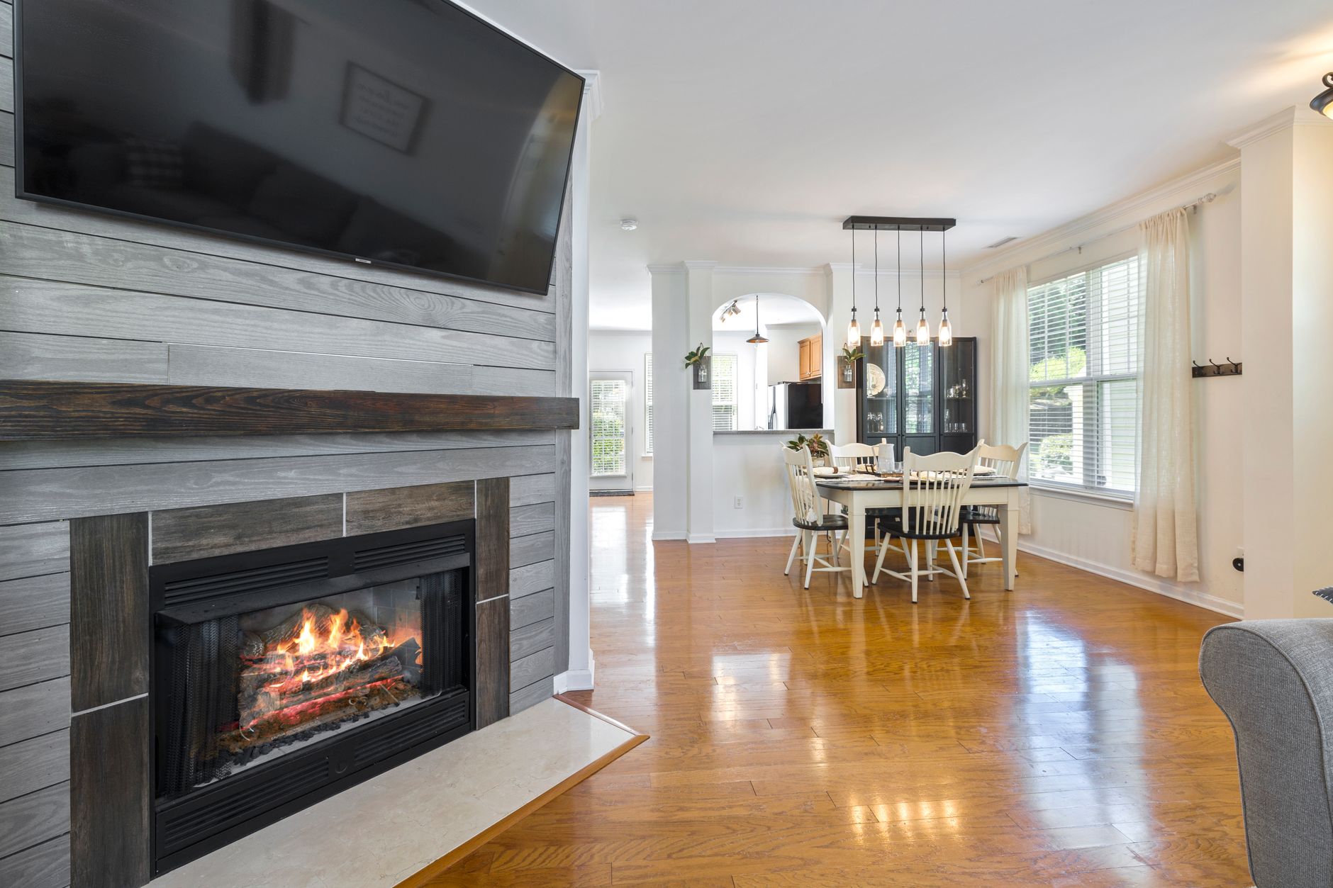 A gas fireplace below a wall-mounted TV