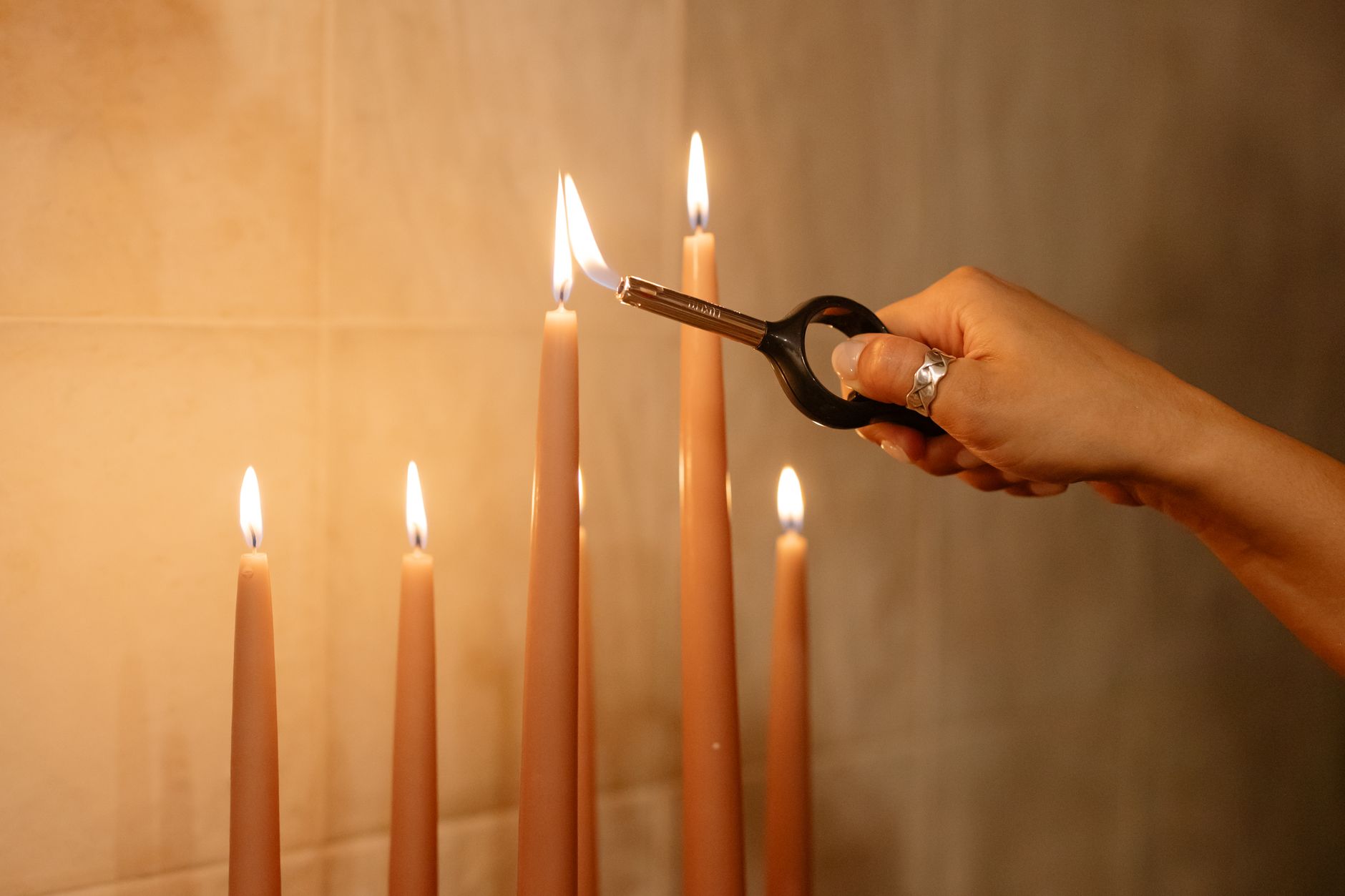 Lighting candles with a long lighter