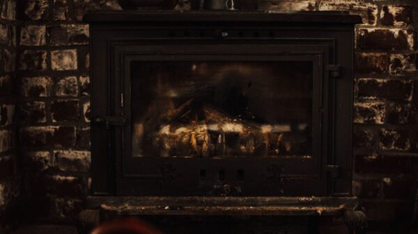 Best fireplace screen: a wood stove set into a brick fireplace