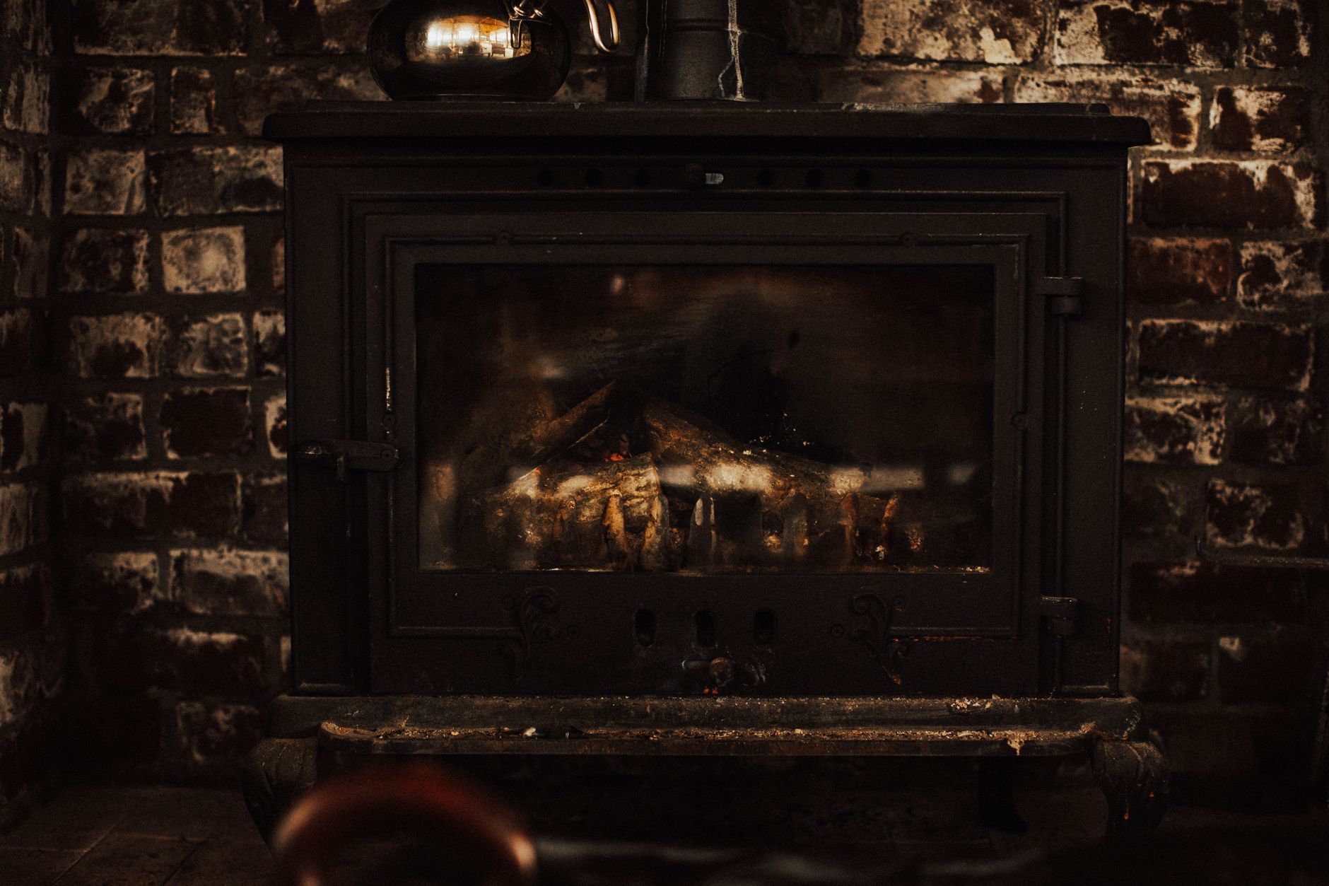 Best fireplace screen: a wood stove set into a brick fireplace