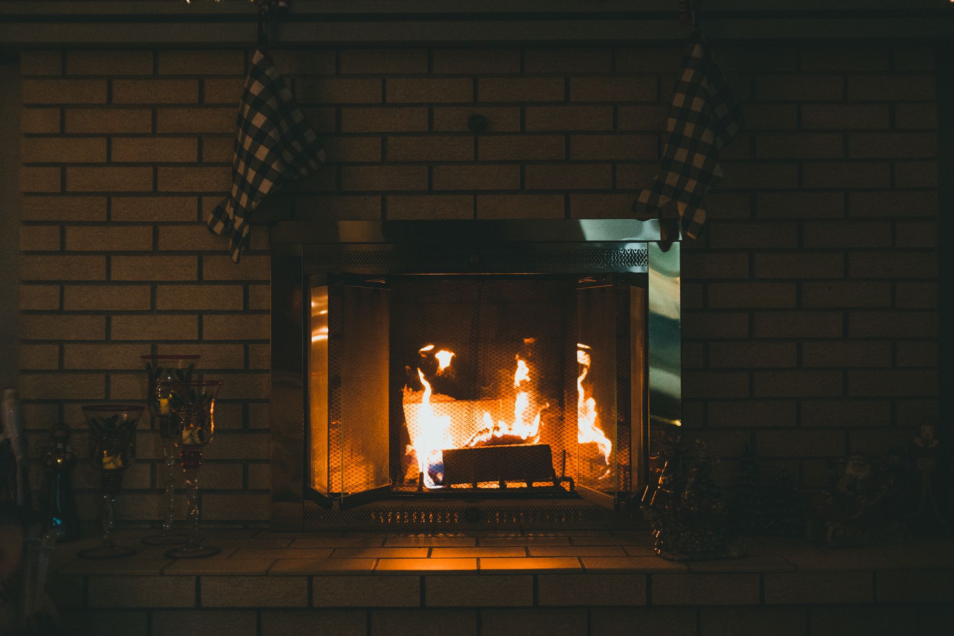 A fire burning in a brick fireplace