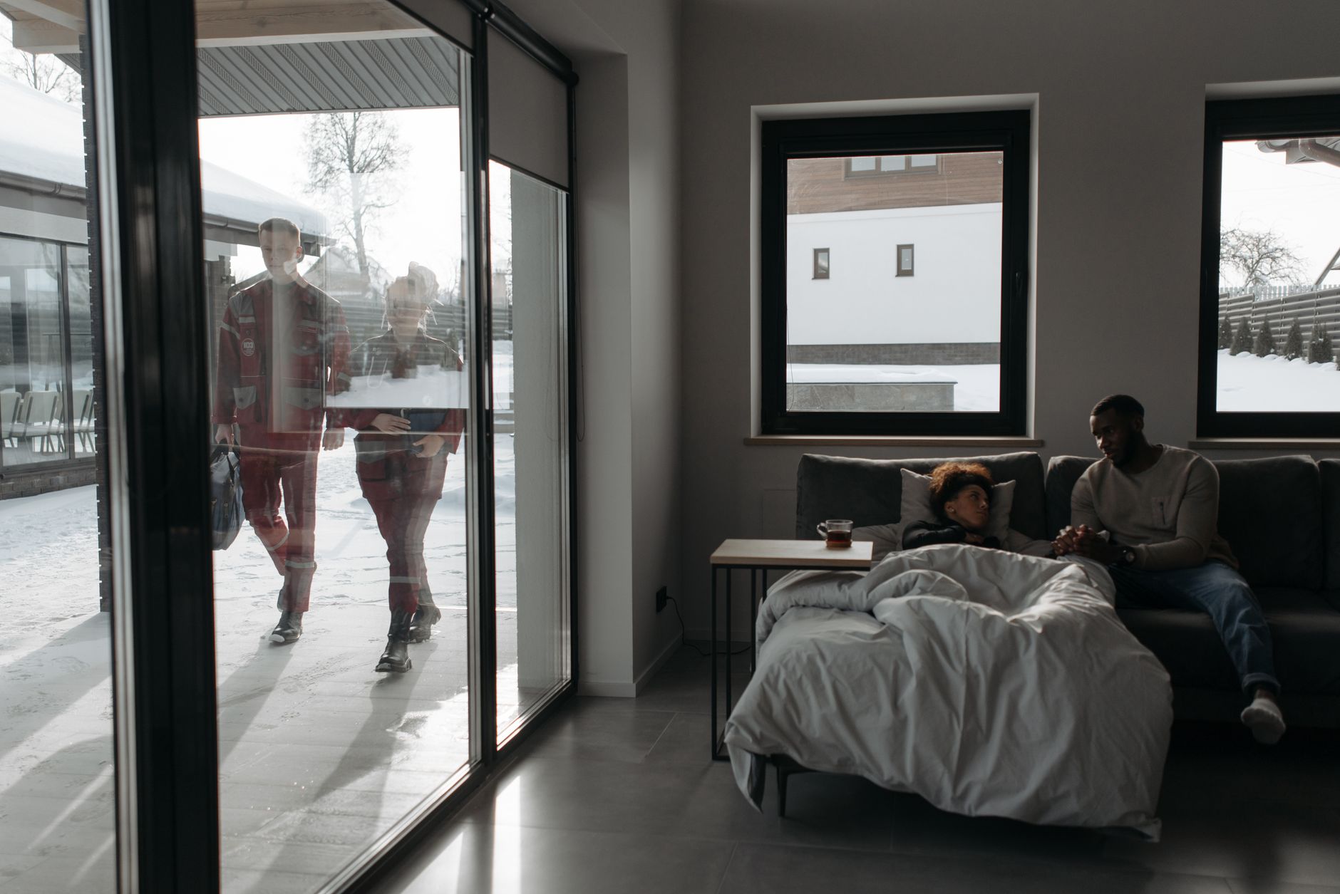 A family on a sofa by snowy windows