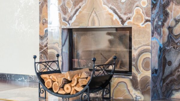 Best fireplace tool set: a log holder beside a marble fireplace