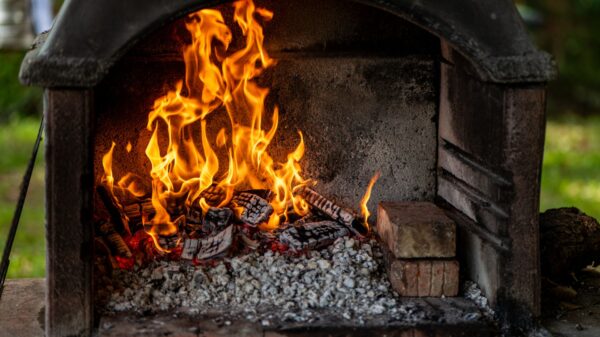 Best fireplace wood: a wood fire burning in an outdoor brick fireplace