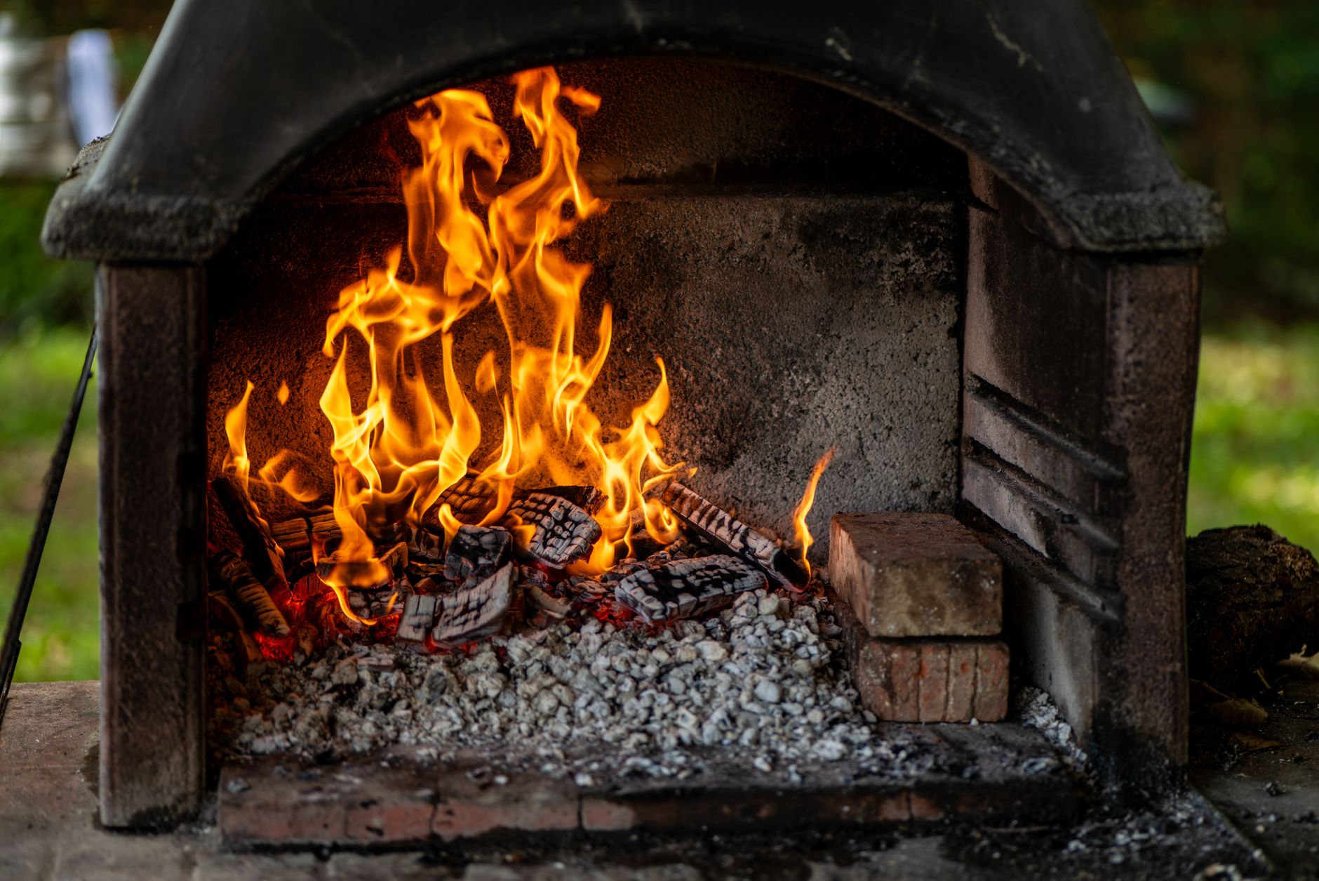 Best fireplace wood: a wood fire burning in an outdoor brick fireplace