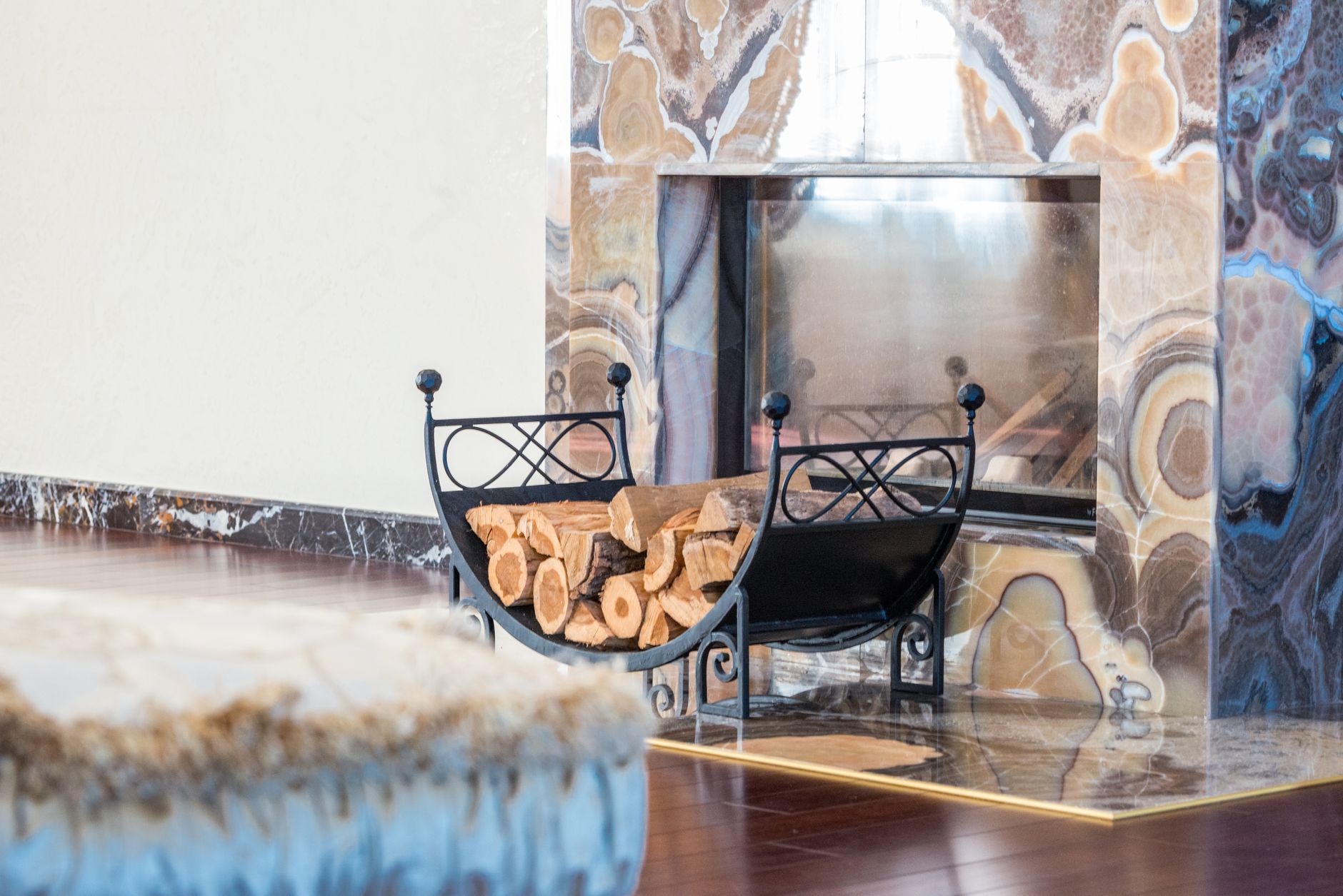 Logs near a fireplace in a living room