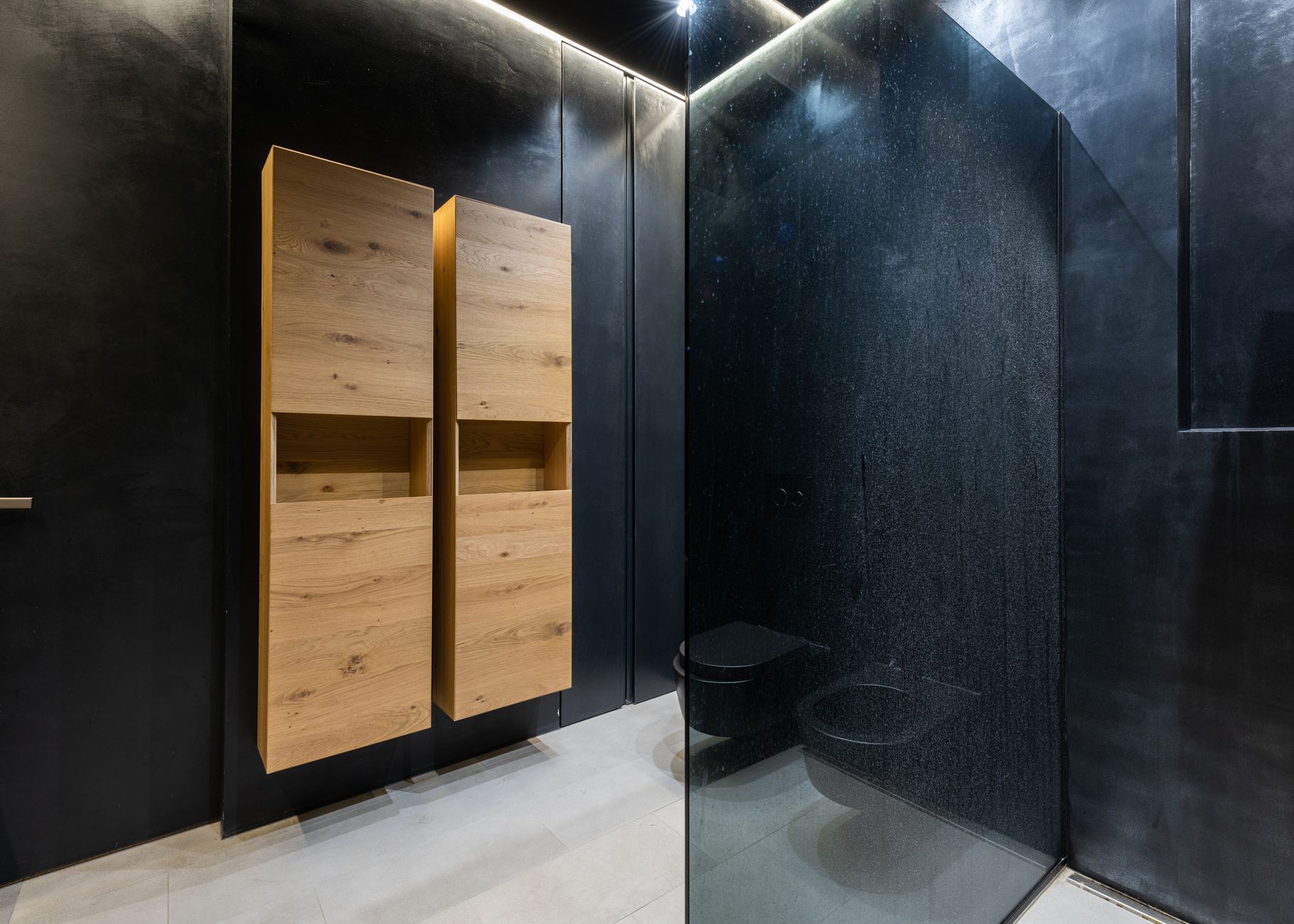 A bathroom with wall cabinets