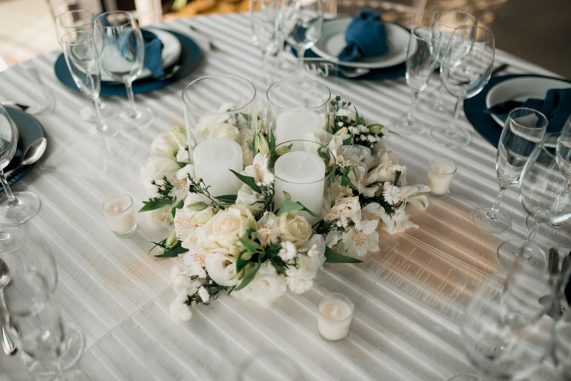 A table set with a floral centerpiece and candles