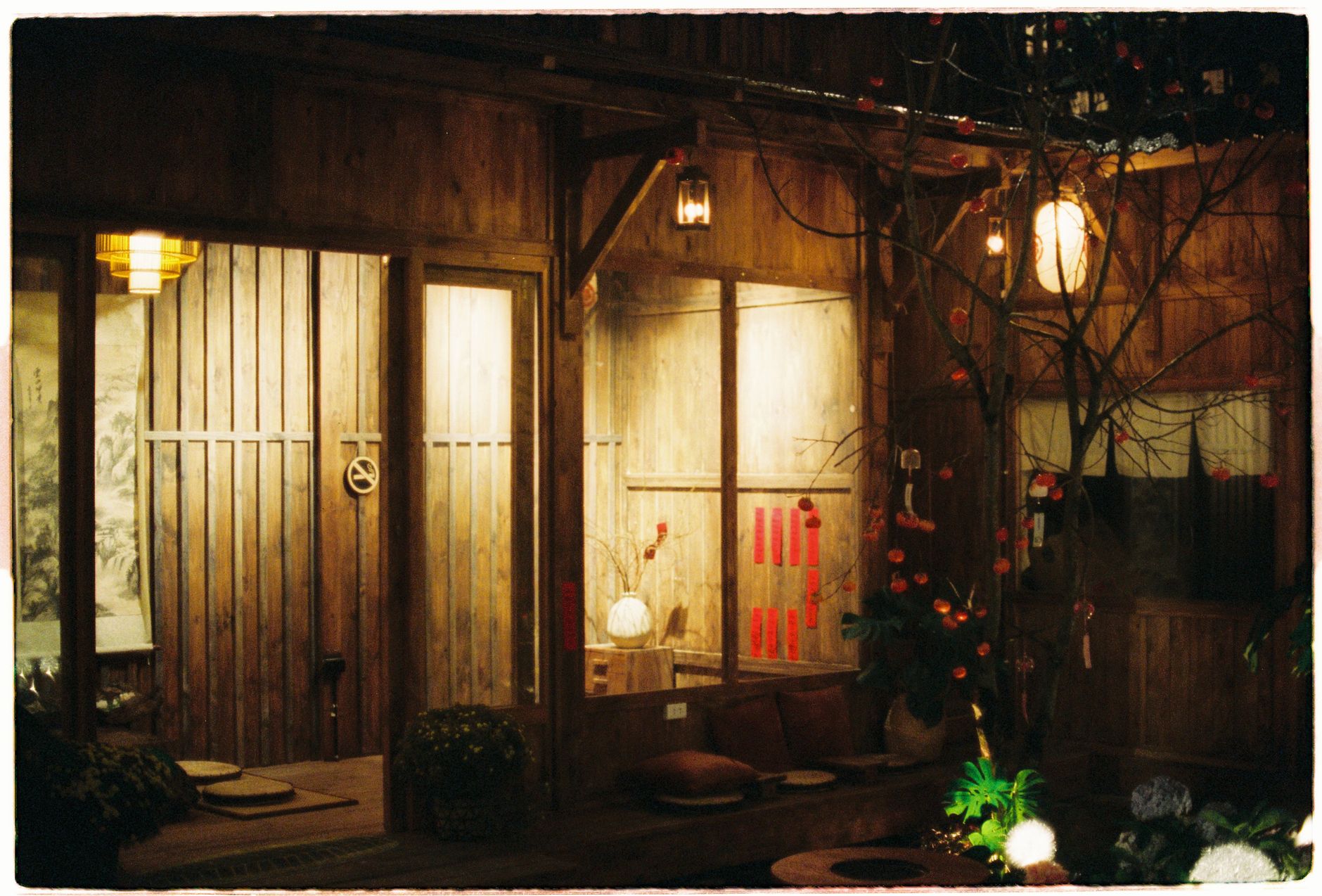 A porch lit by lanterns at night