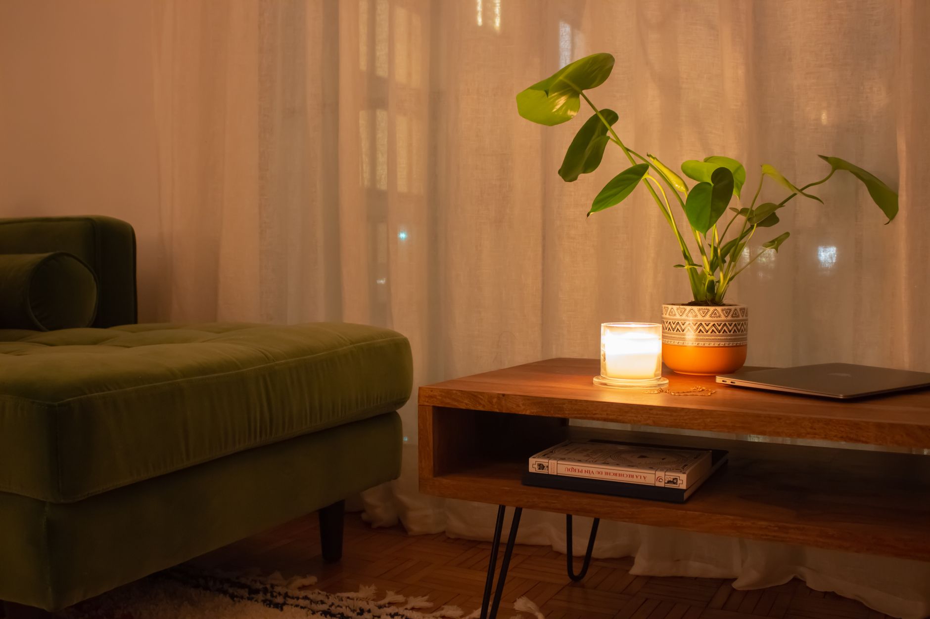 A battery candle glowing on a side table