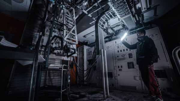 A person shining a flashlight in a dark utility room