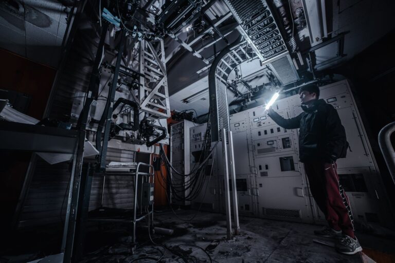 A person shining a flashlight in a dark utility room