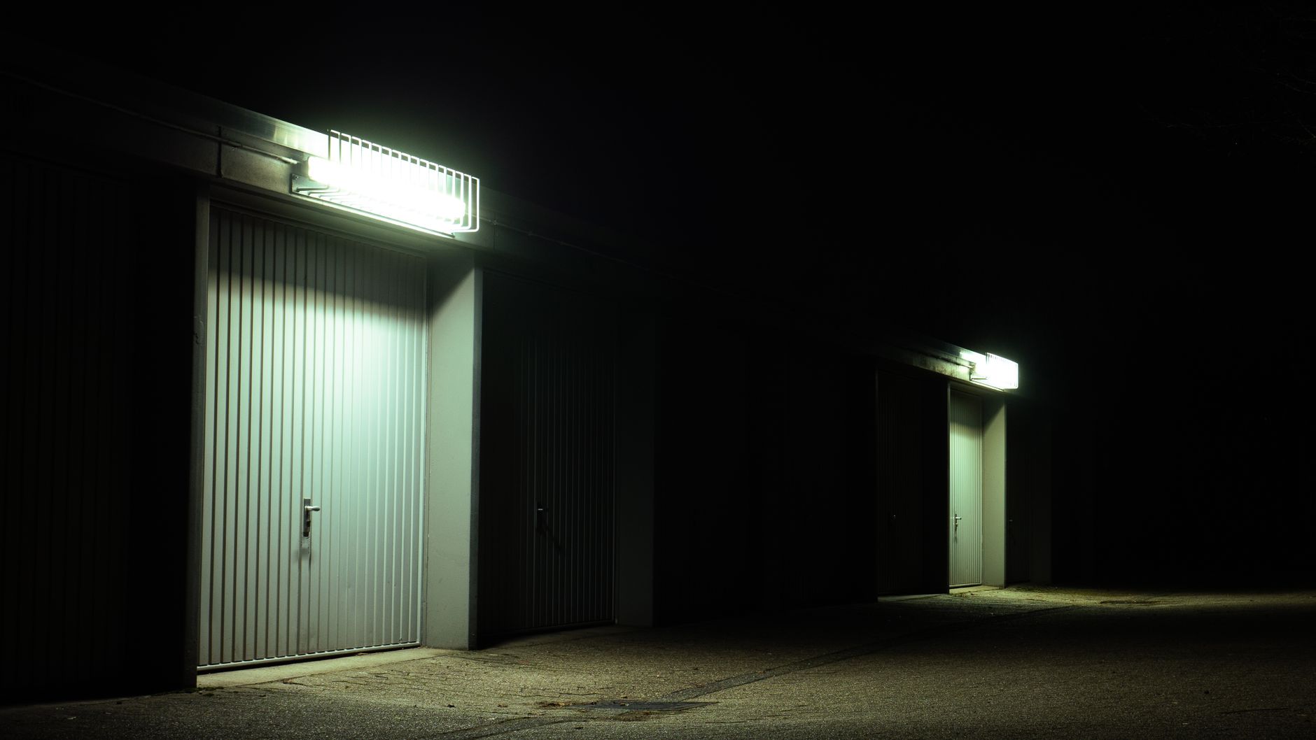 The outside of a garage after dark