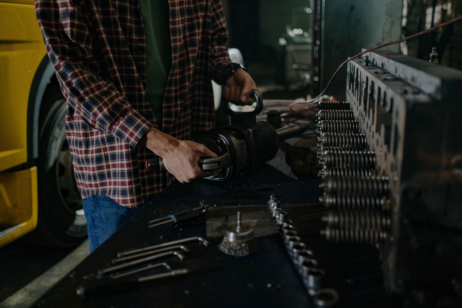 A man working at a cluttered workbench