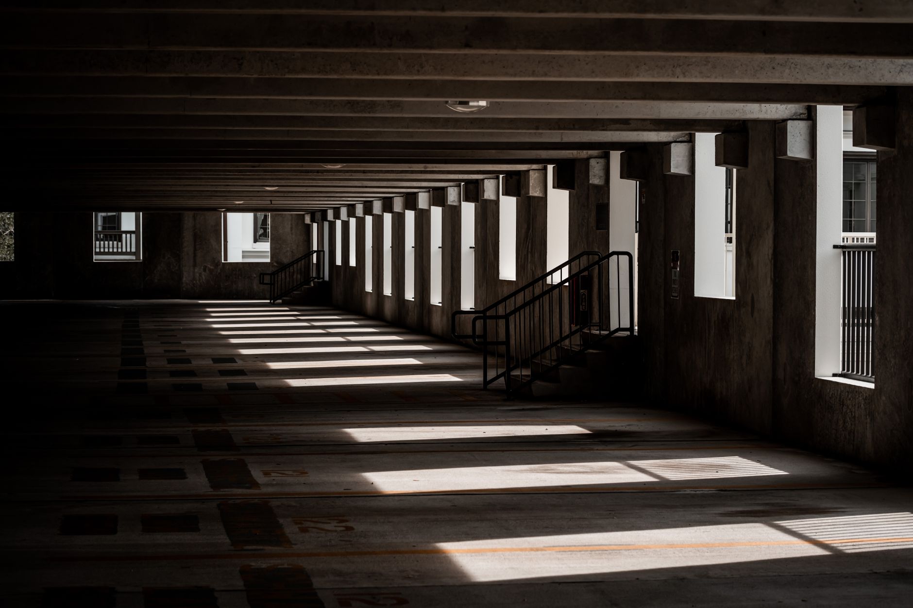 An empty parking structure with light on the floor