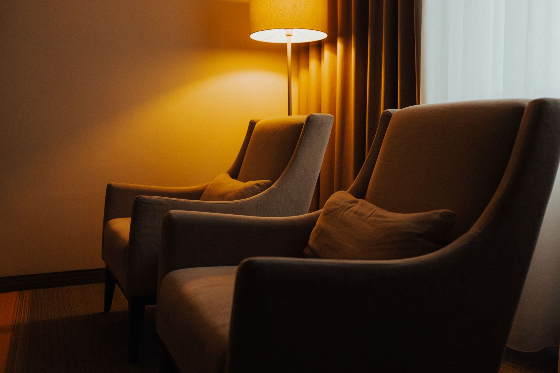 An armchair with a lamp beside it for reading