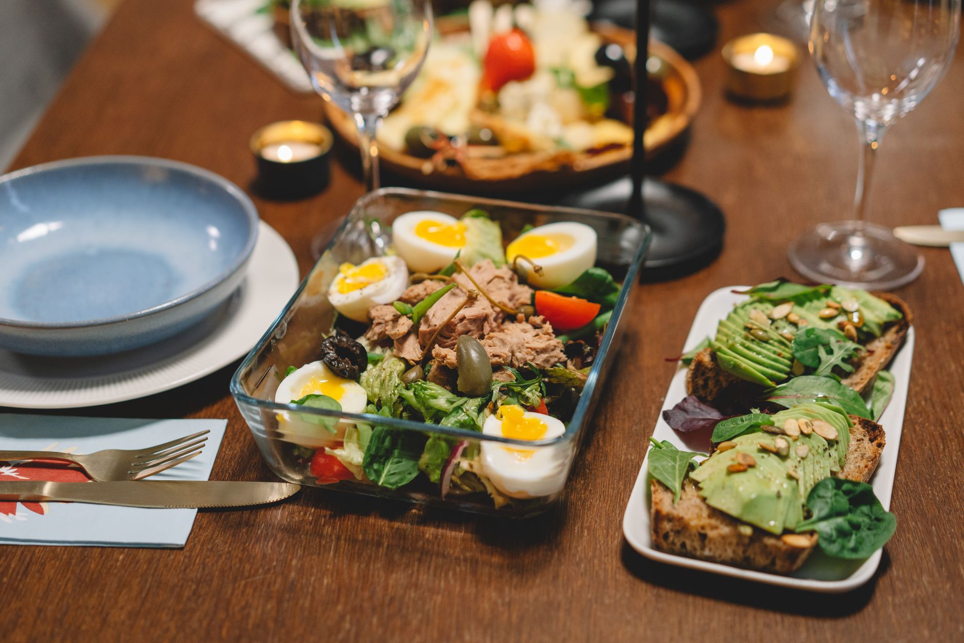 A glass dish of salad on a dinner table