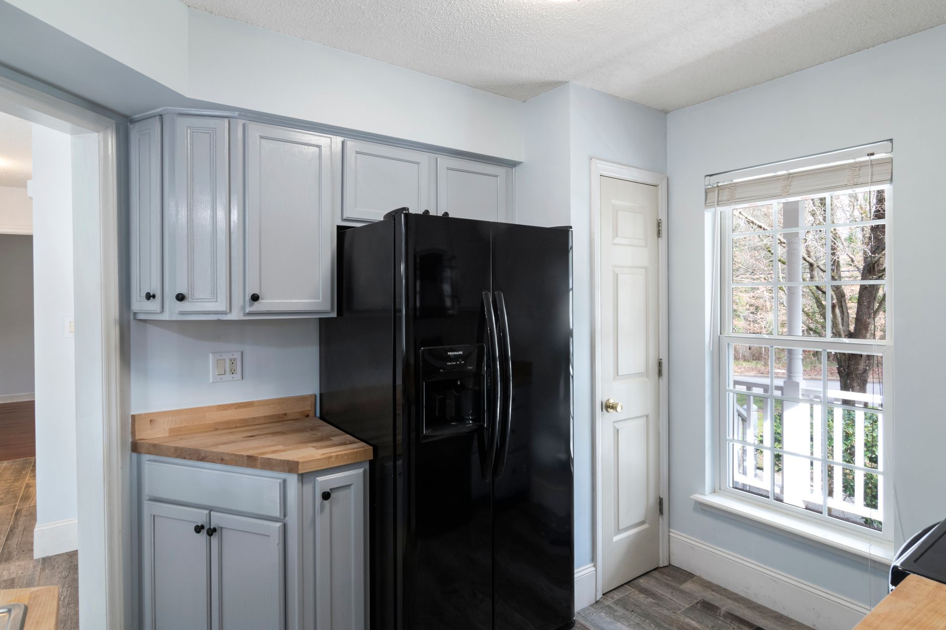 A black refrigerator in a home kitchen