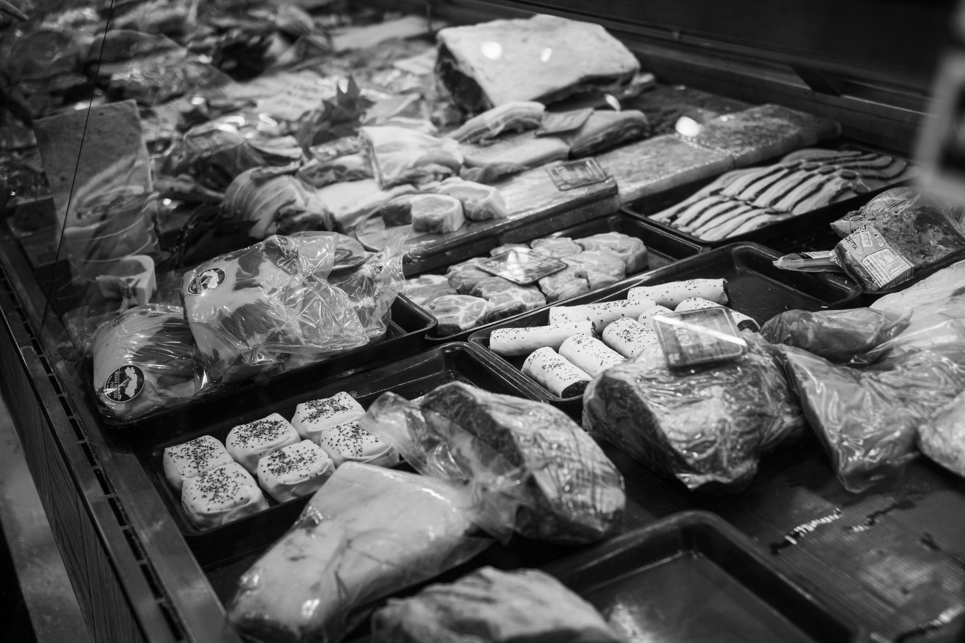 Packaged meats in a store freezer case
