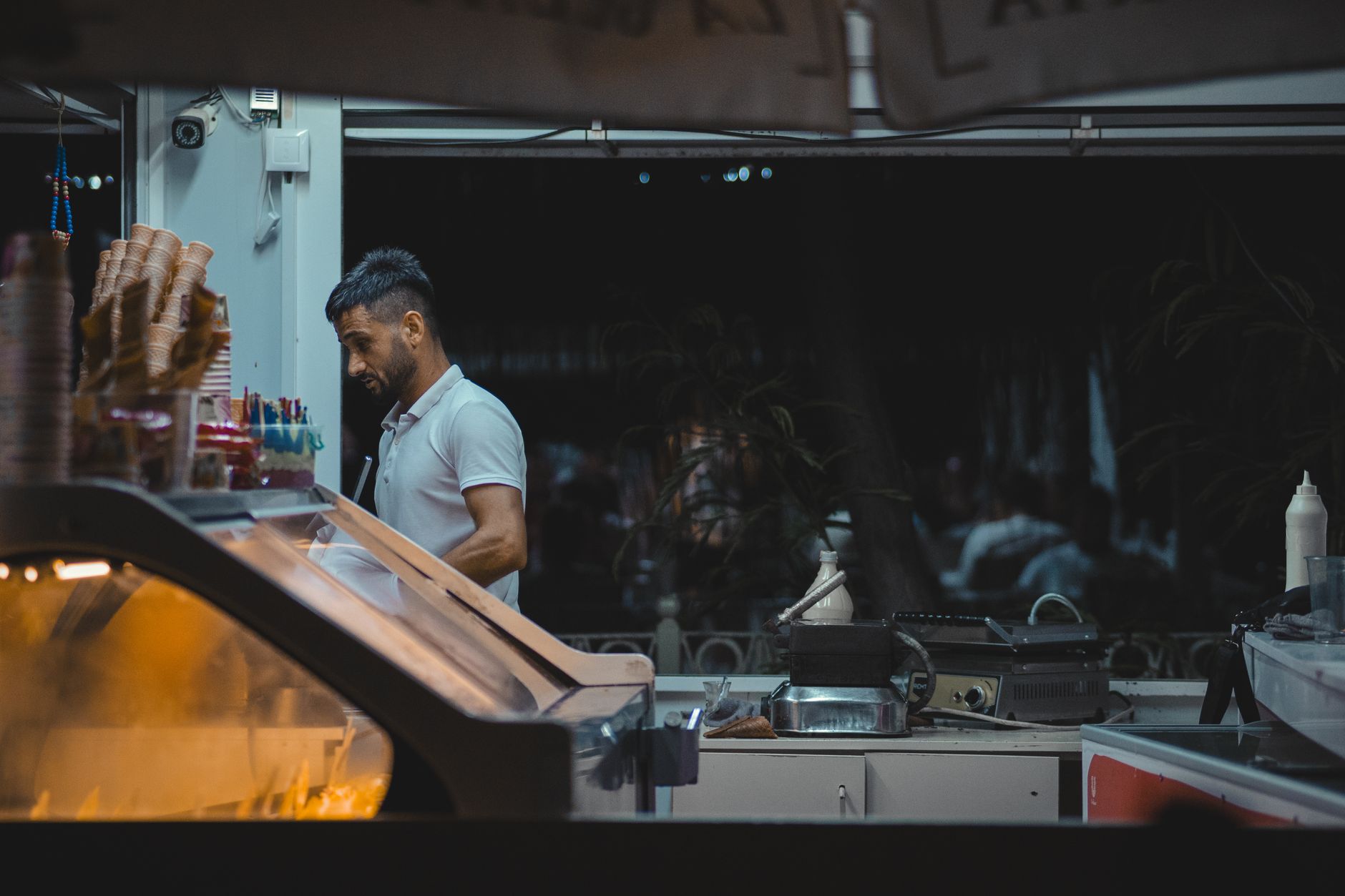A man at a food stall counter