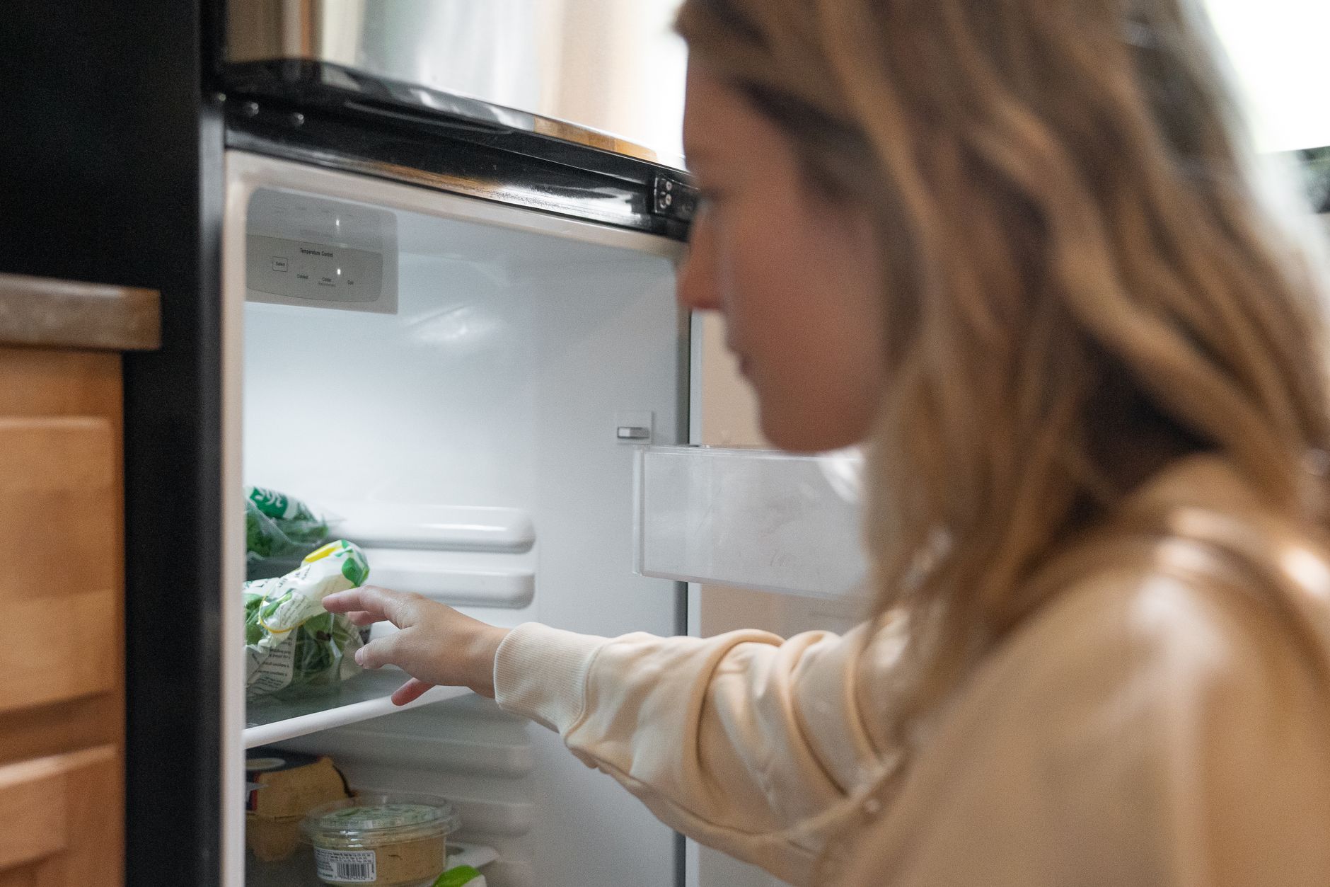 Best freezer lock: a woman reaching into a refrigerator