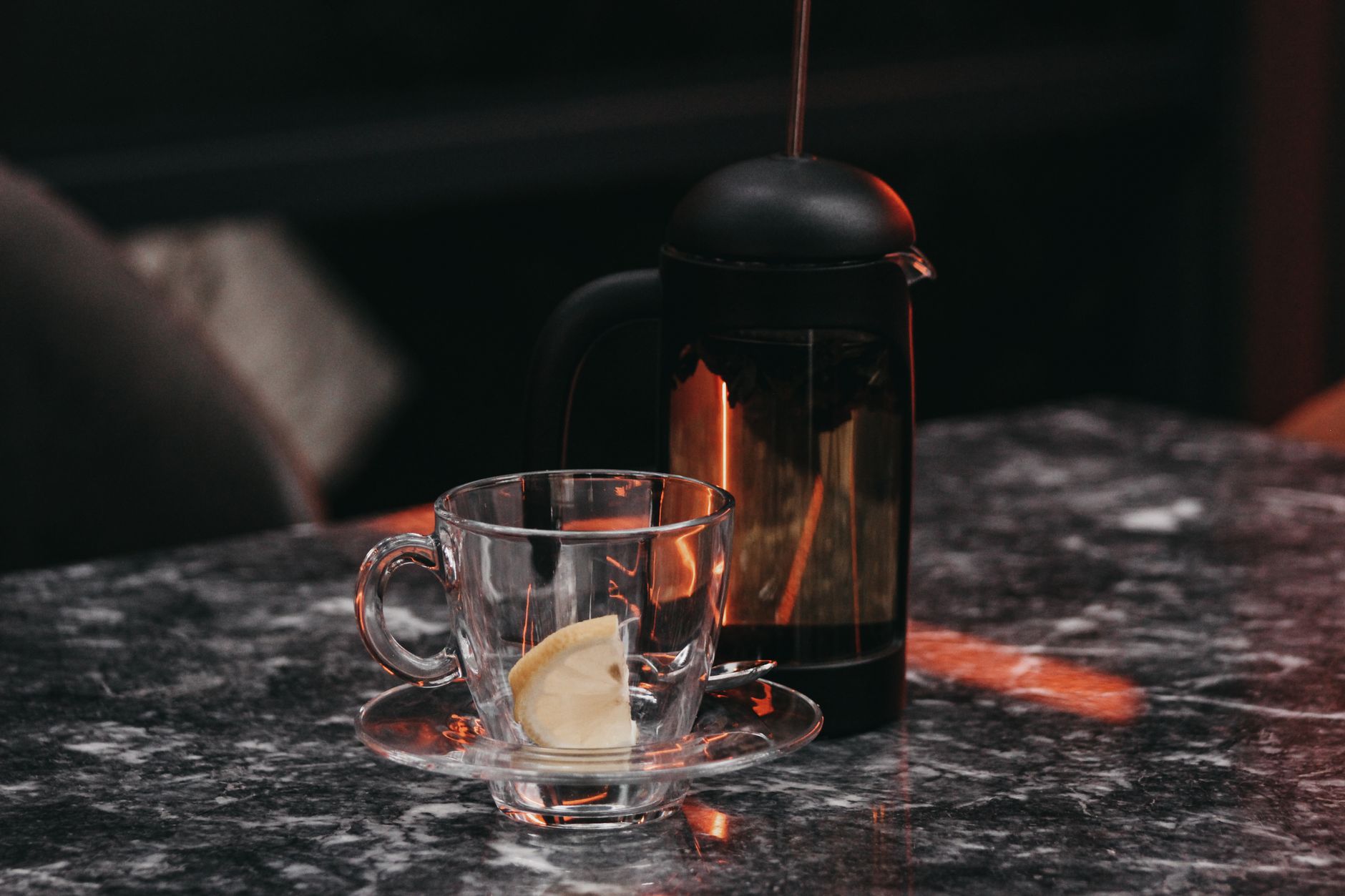 A glass coffee press filled with brewed coffee