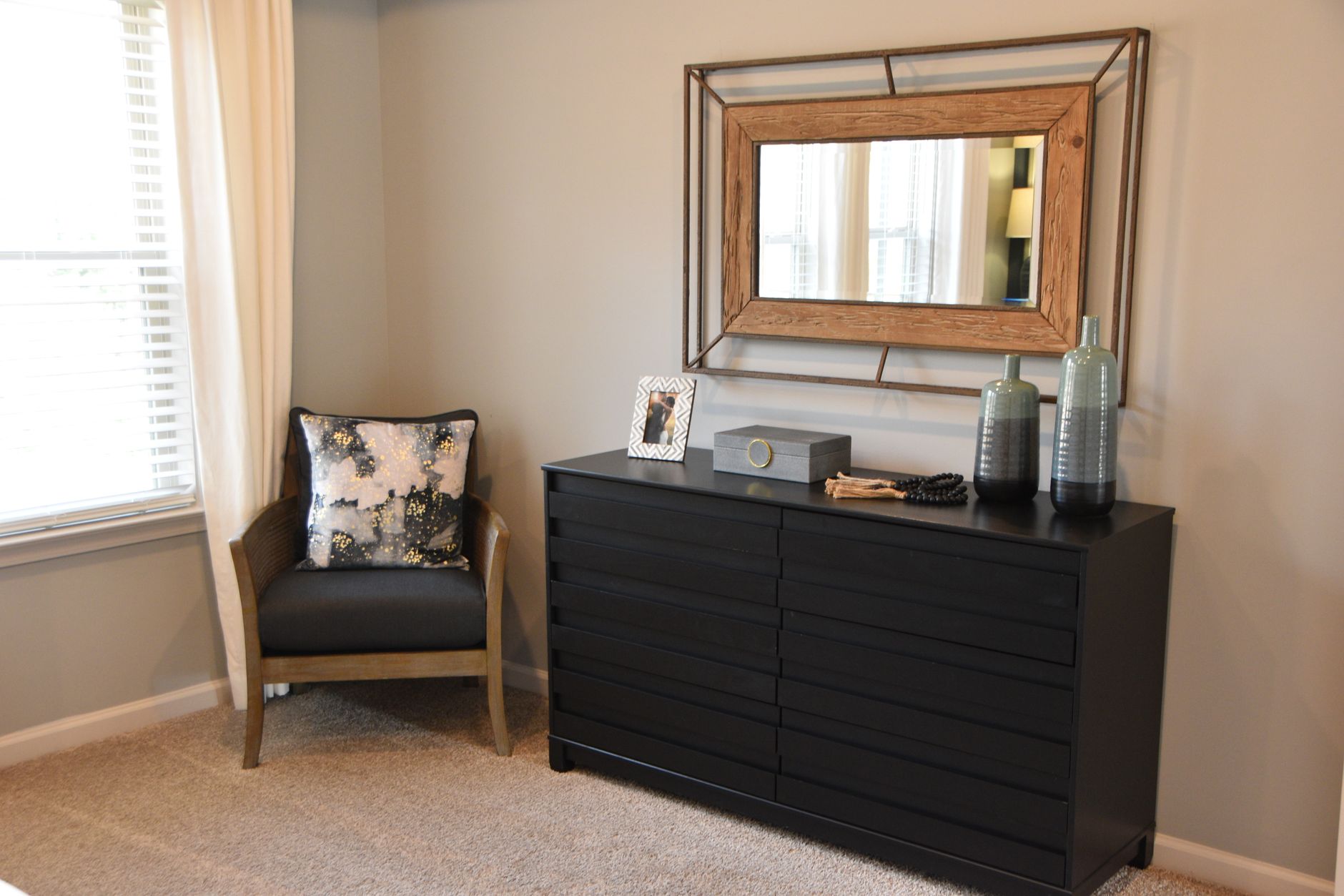 A dresser and armchair in a bedroom