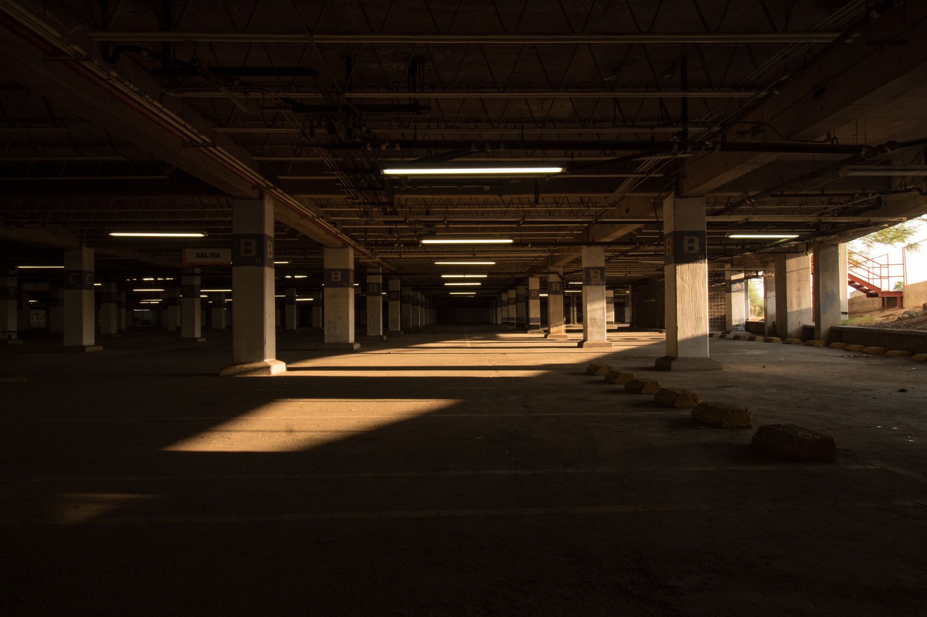 Best garage floor mat: a dim parking garage with concrete floors