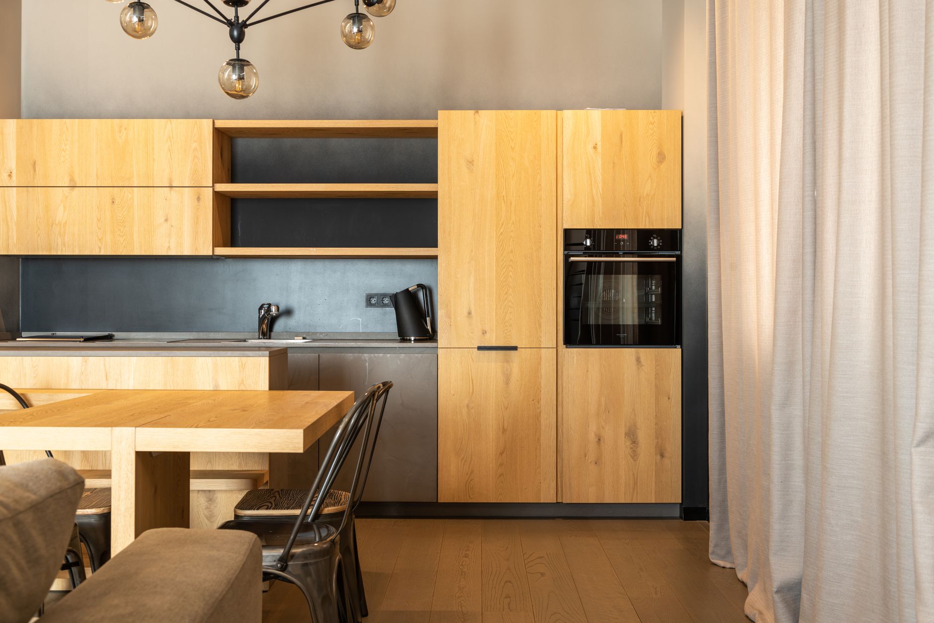 A modern home kitchen with a sink and cabinets