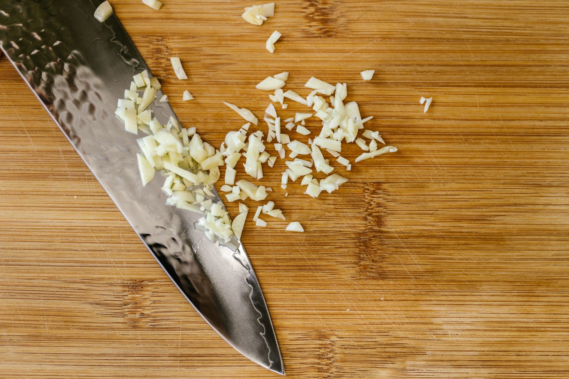 Minced garlic beside a chef knife