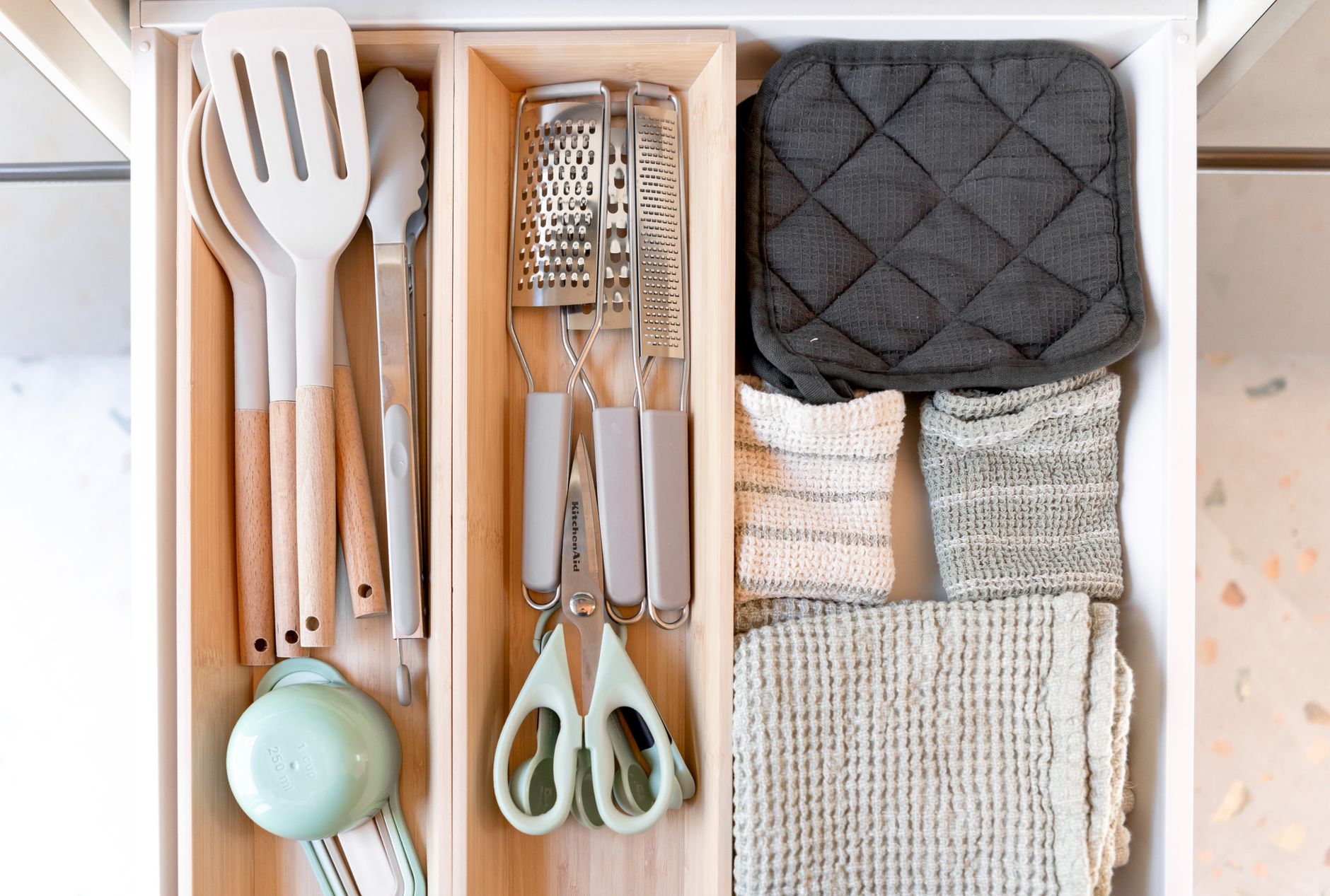 Utensils and towels in a drawer organizer