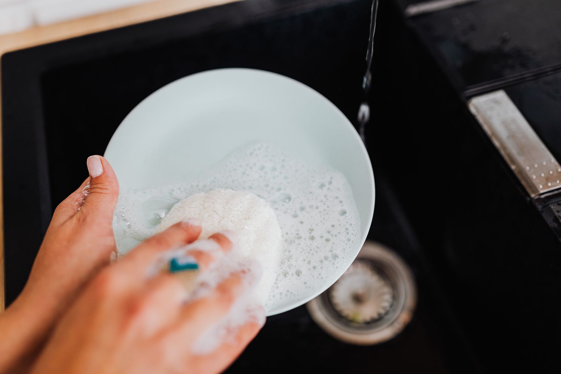 Washing a plate in a sink