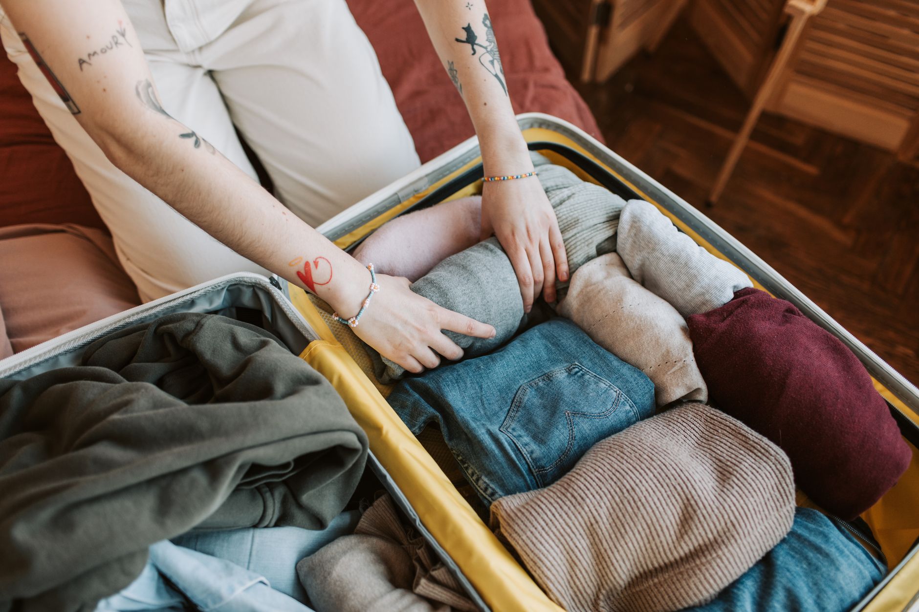 Packing folded clothes into a suitcase