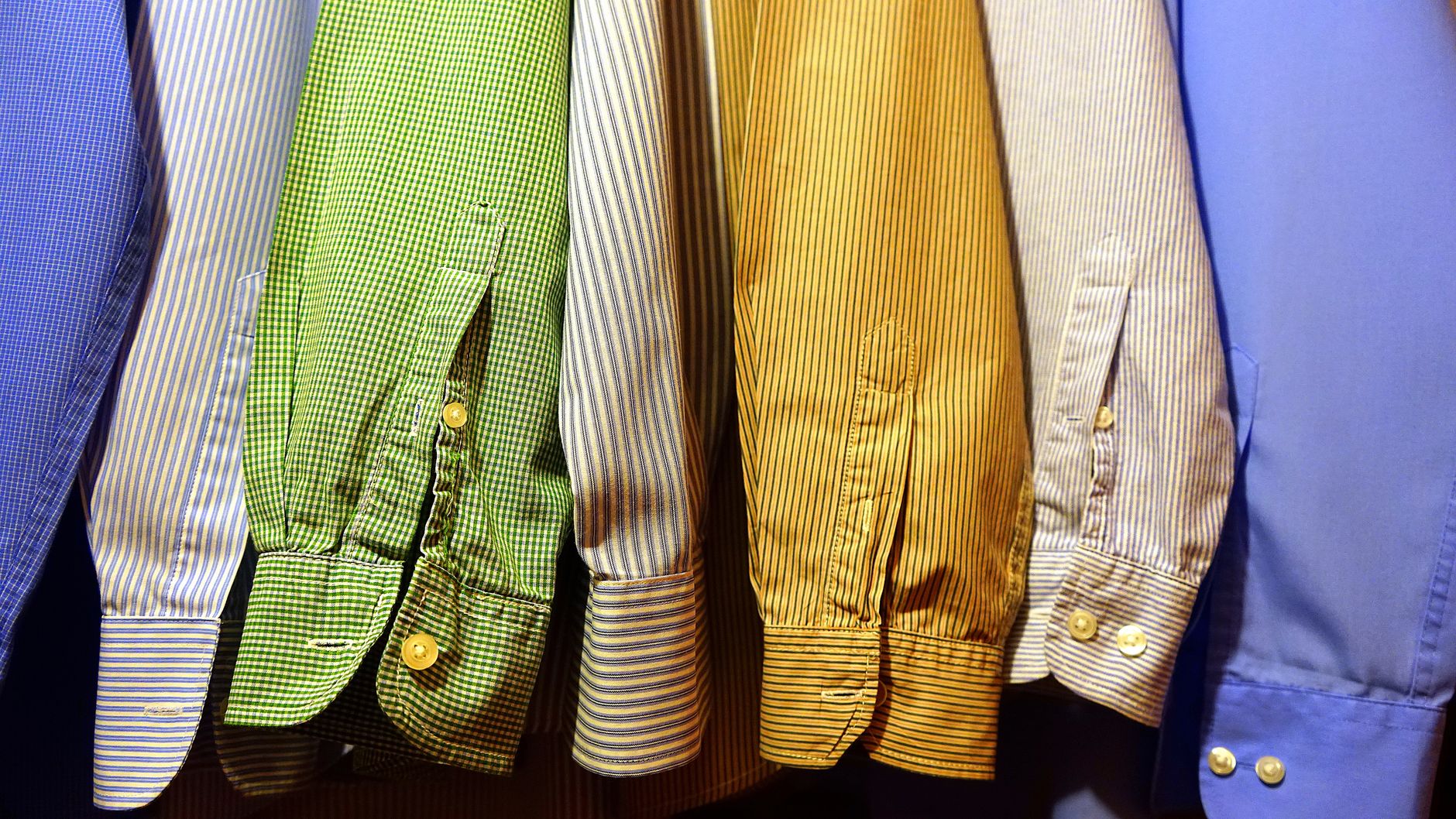 Dress shirts hanging in a row