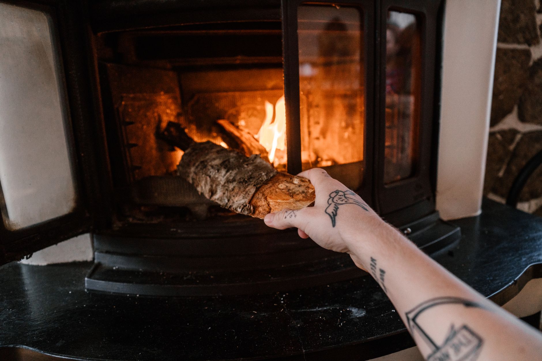 Adding a log to a wood stove