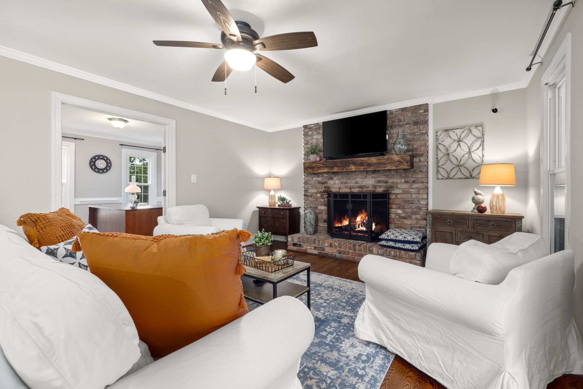 A living room with a brick fireplace