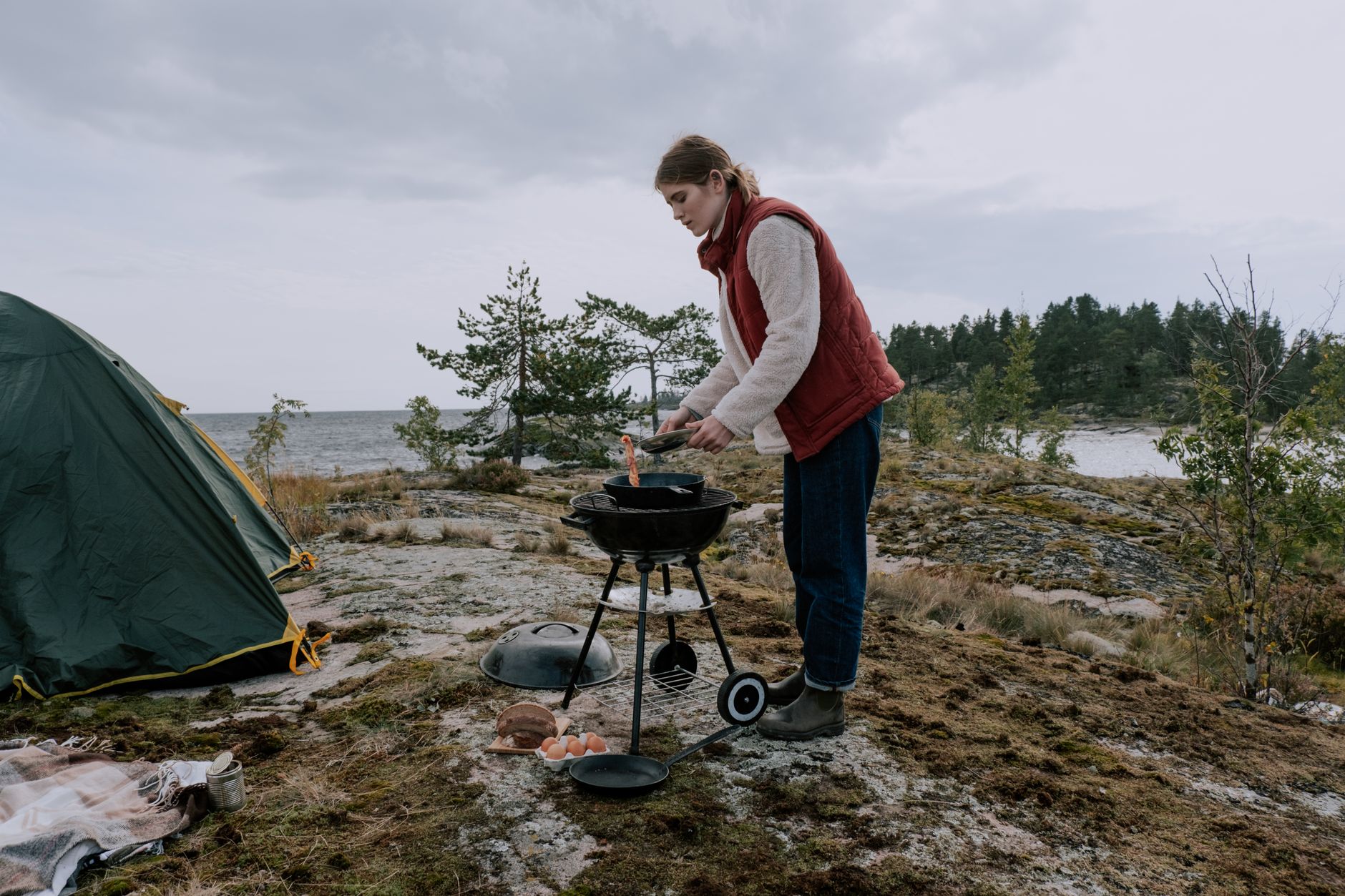 A small charcoal grill set up at a campsite