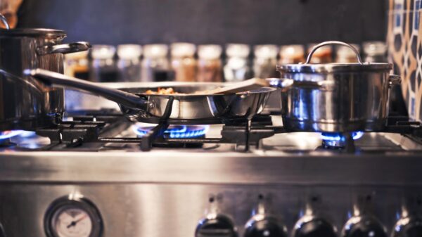 Best gas stove pans: a pan cooking over a gas burner flame