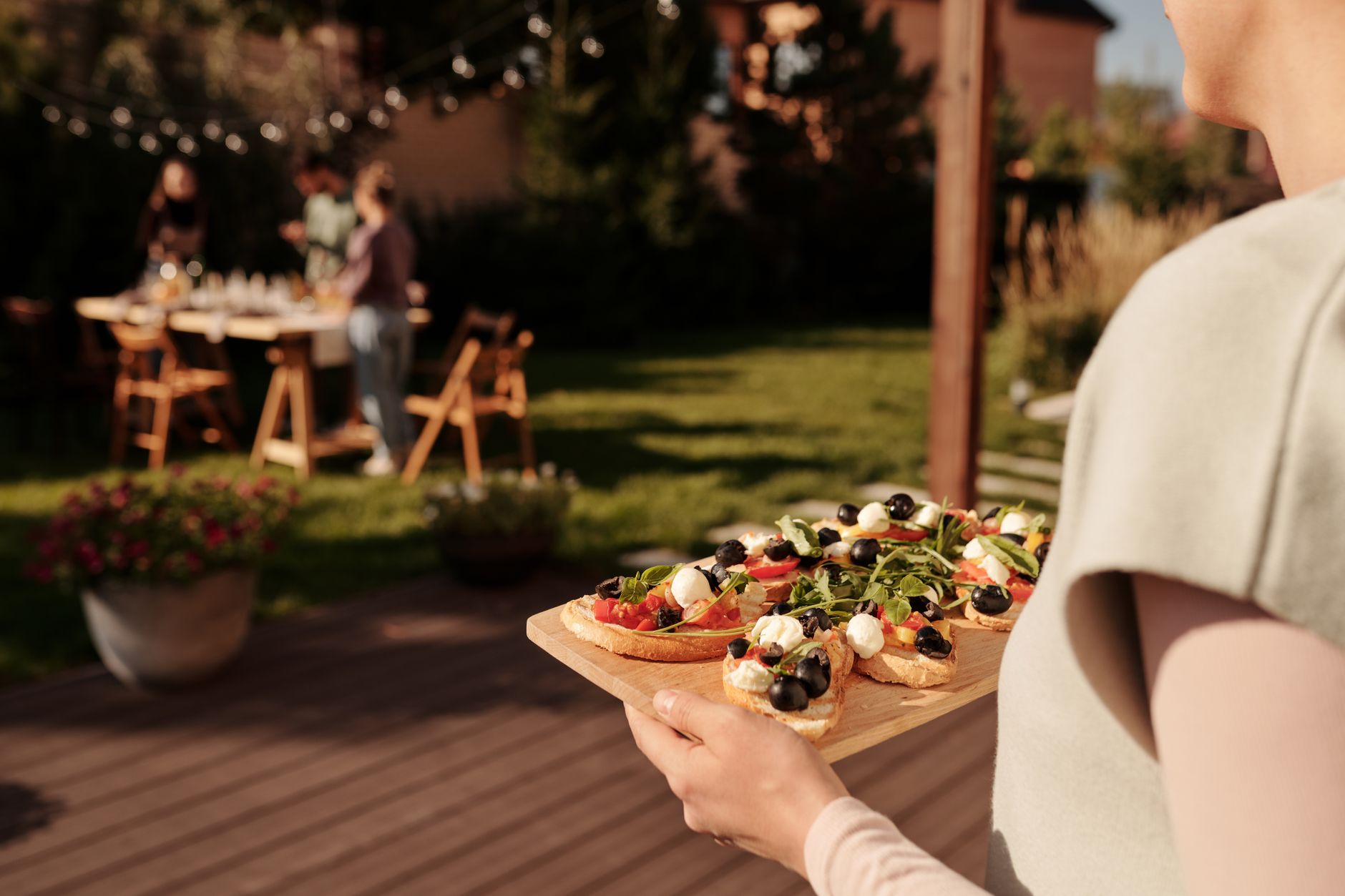 People gathering in a backyard on a summer day