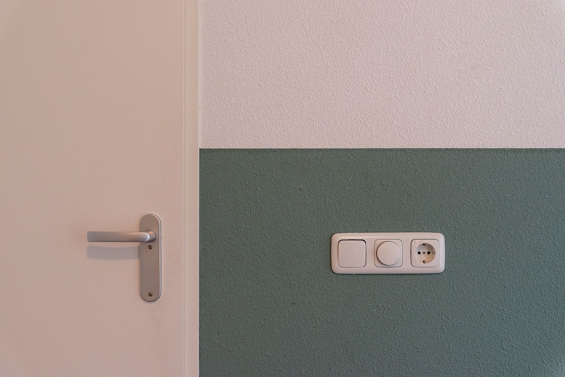 A wall outlet beside a door