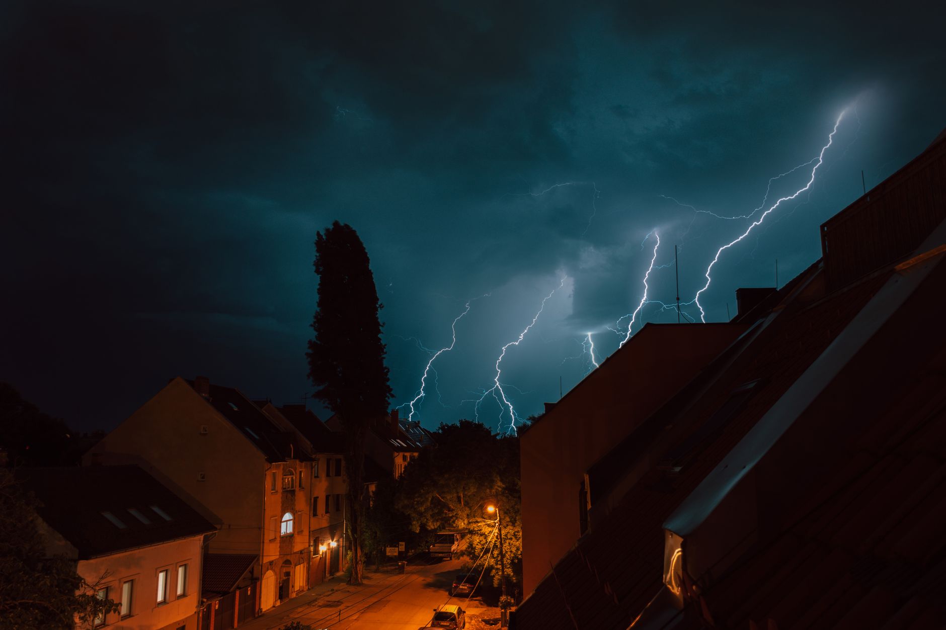 Lightning over houses at night